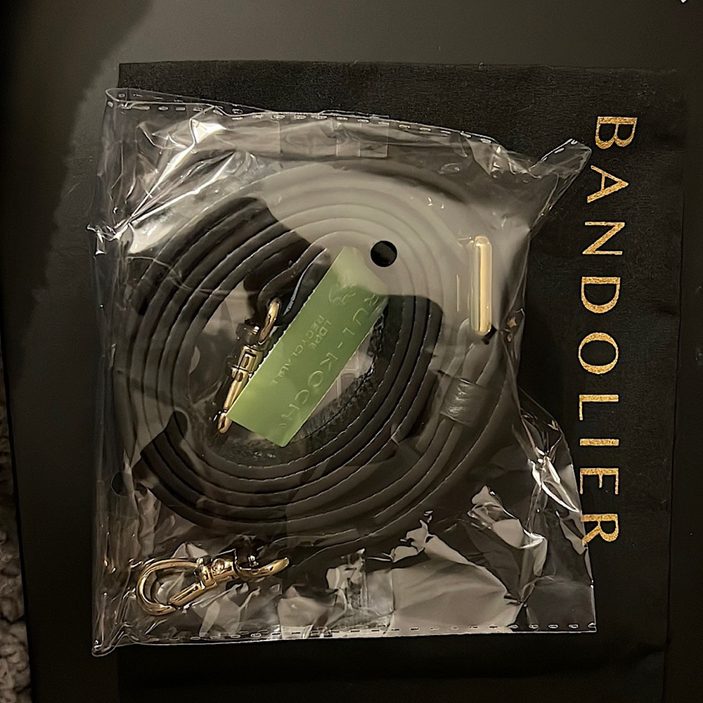 Black leather with gold hardware strap. Case is not included.